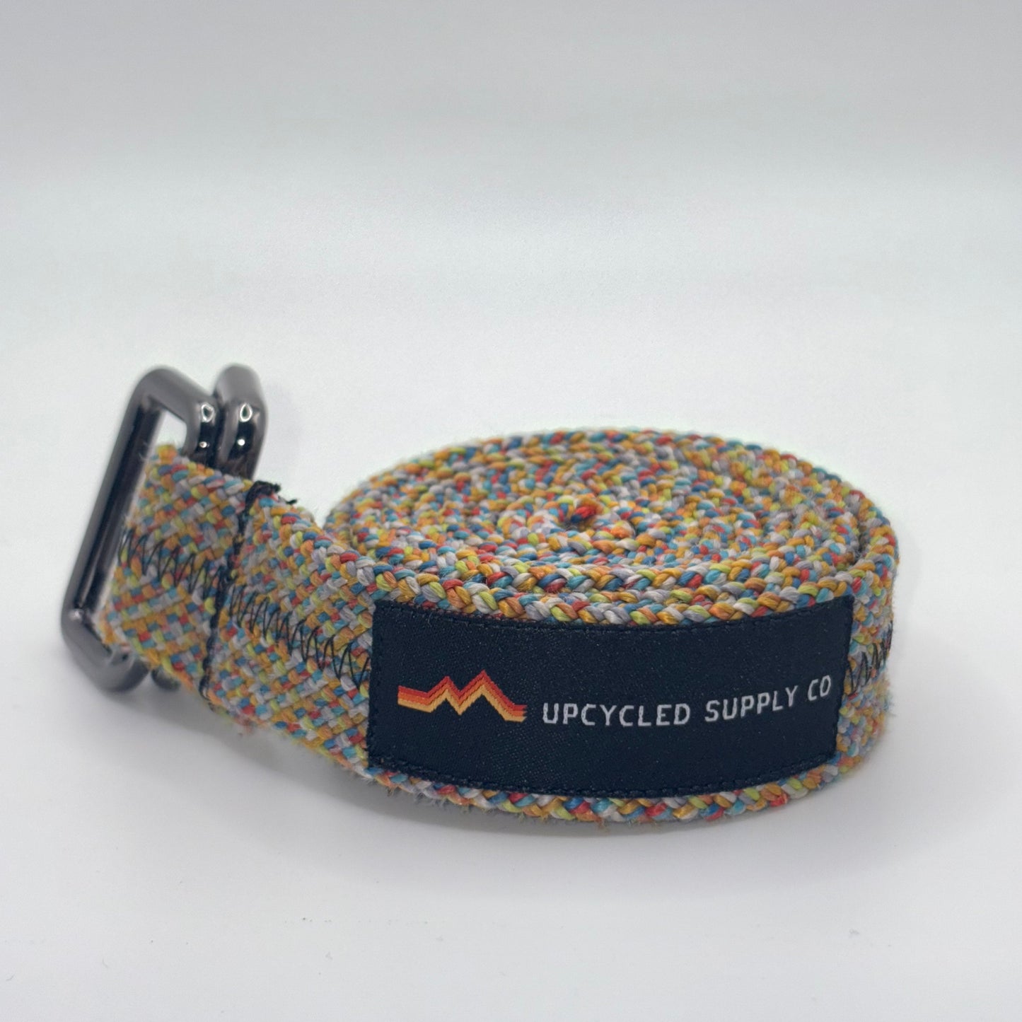Multicolored woven belt with a brand label on a white background