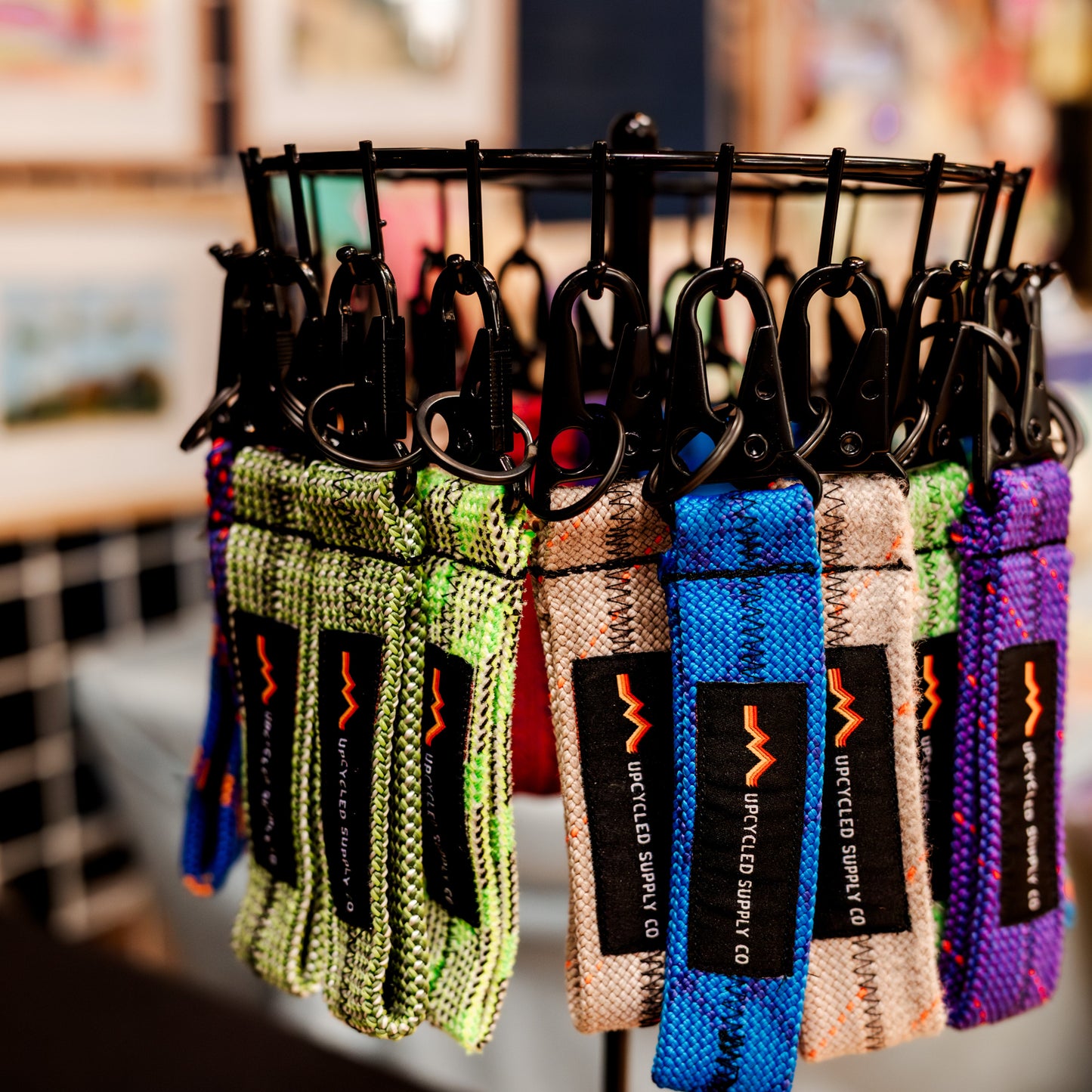 Colorful keychains on a display stand with blurred background
