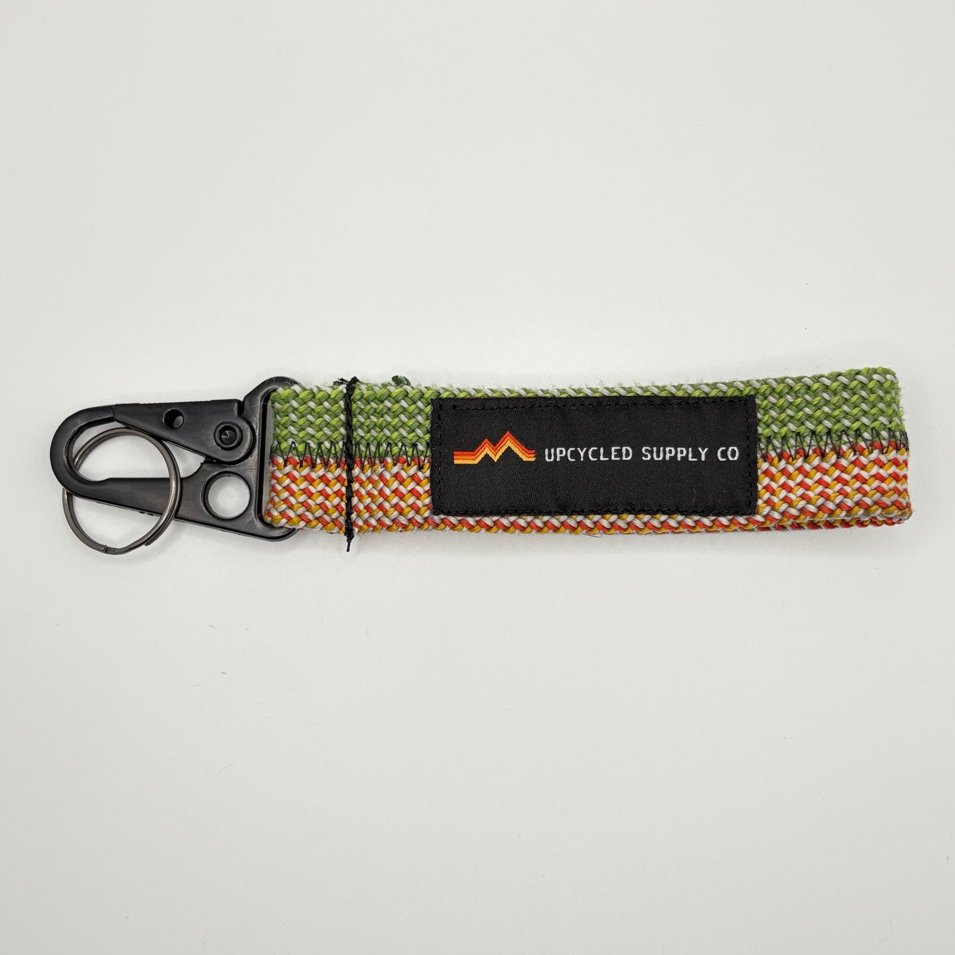 Keychain with colorful strap and black tag on a light gray background