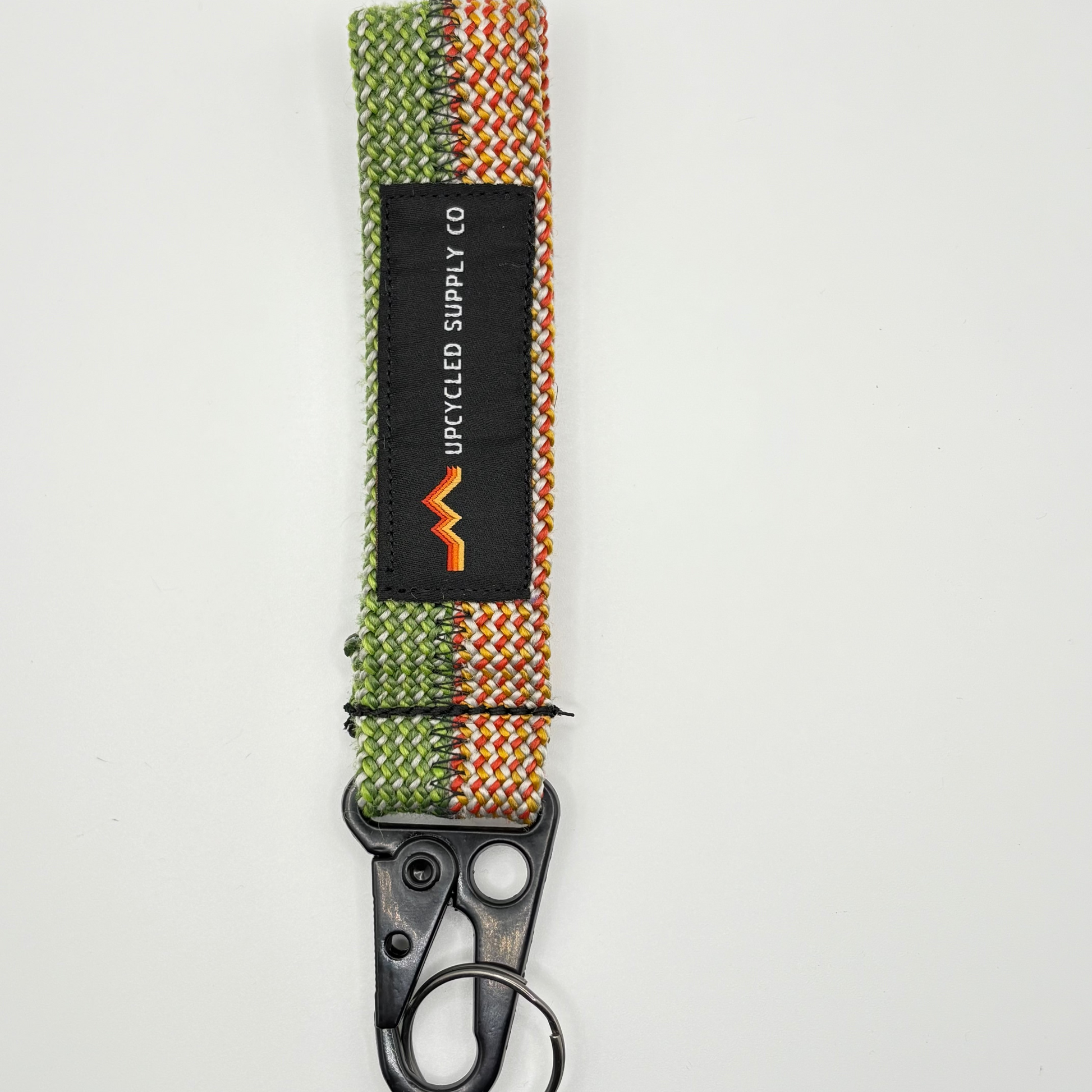 Keychain with woven design and black clip on a white background