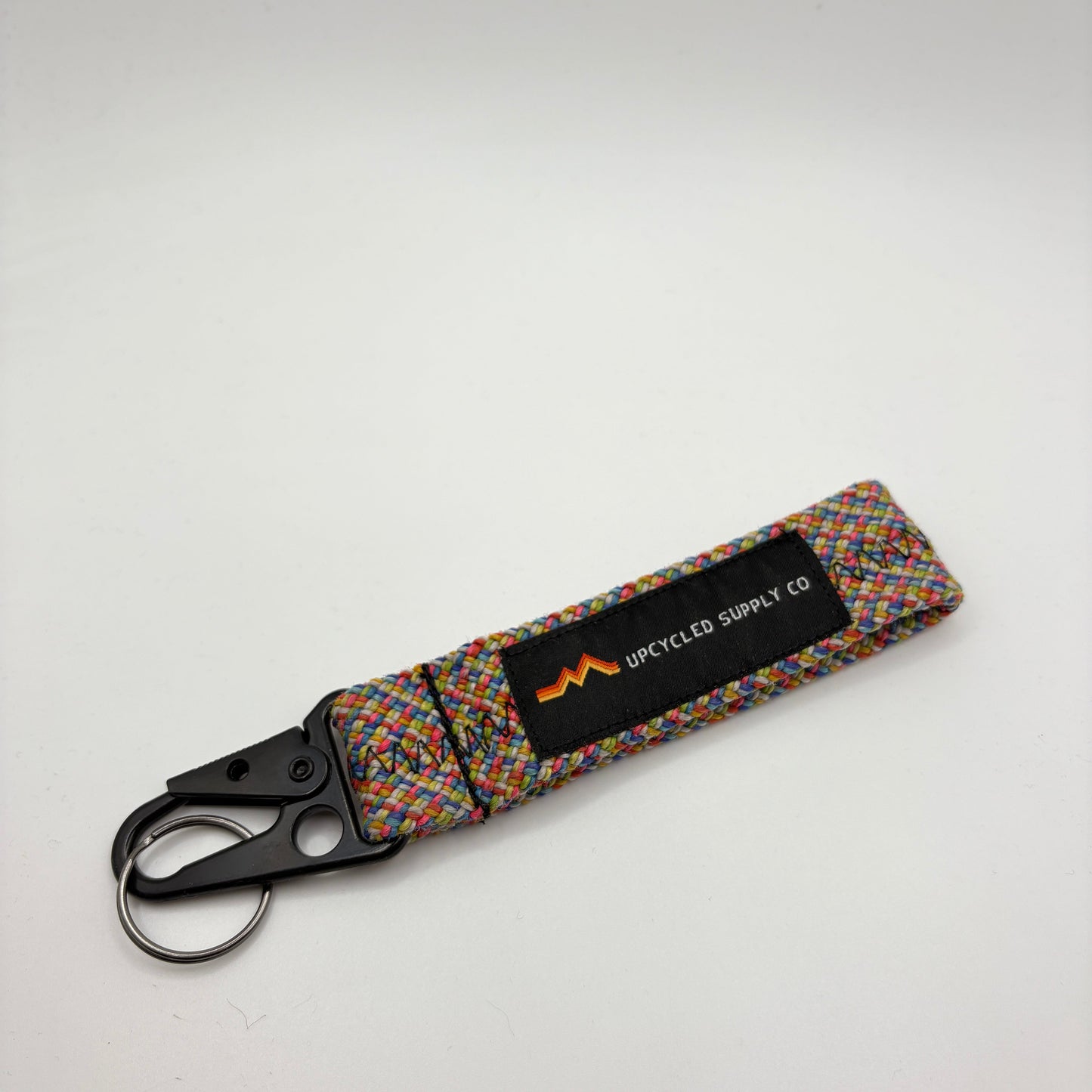 Multicolored keychain with a black label on a white background