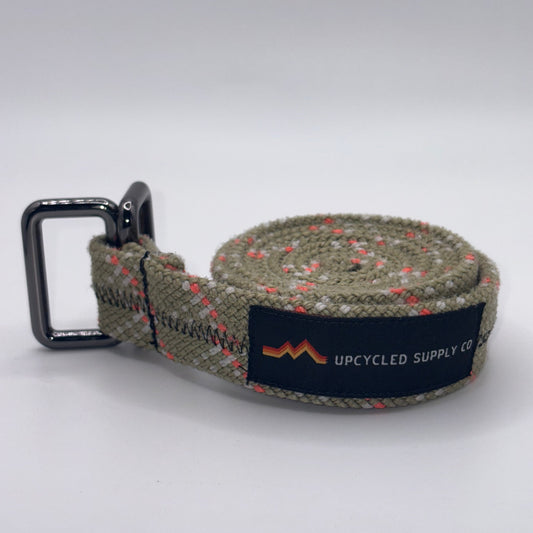 Green woven belt with a black buckle on a white background