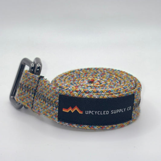 Multicolored woven belt with a brand label on a white background