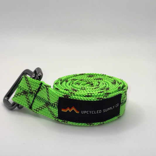 Green webbing strap with a brand logo on a white background