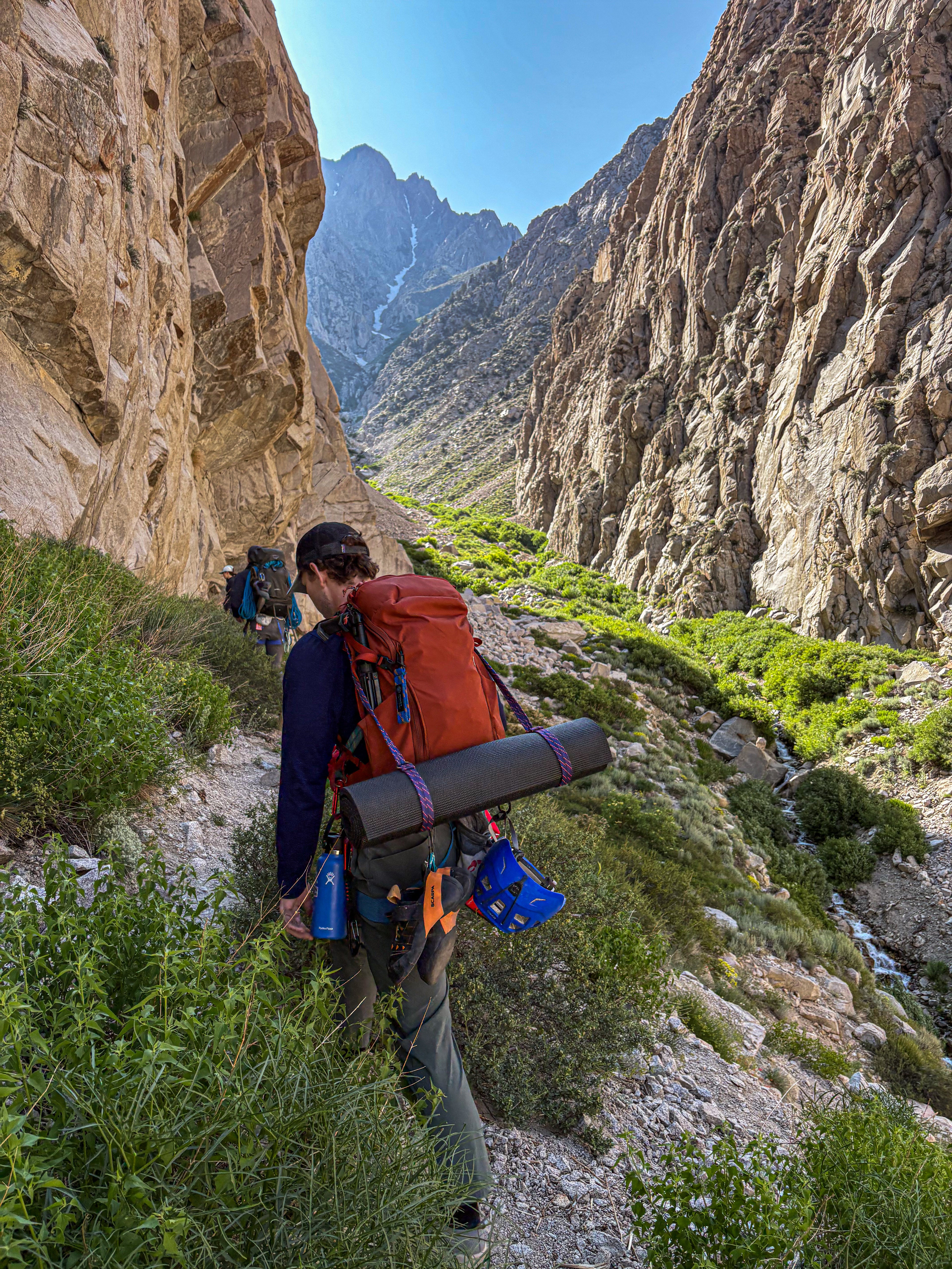 Adventure-ready yoga mat strap made from retired climbing rope, shown on a hiker in the mountains.
