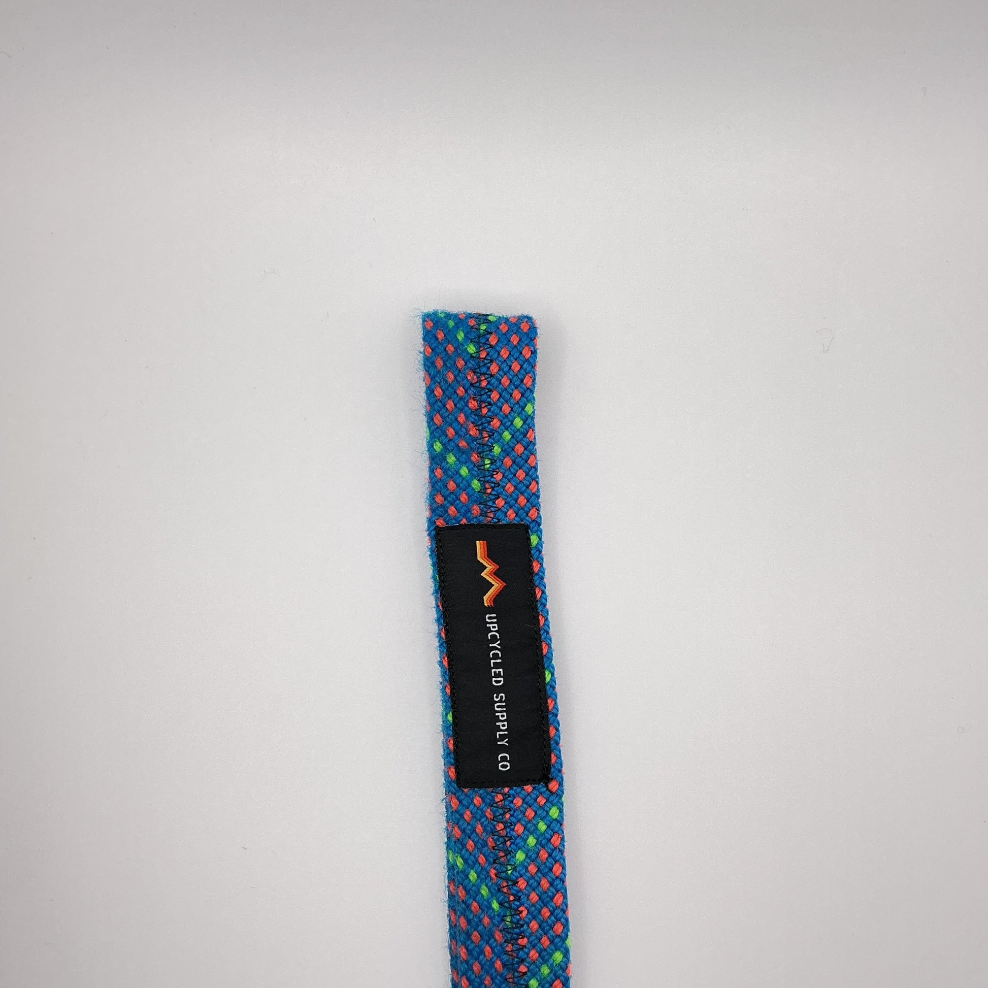 Multicolored headband with a brand label on a light gray background