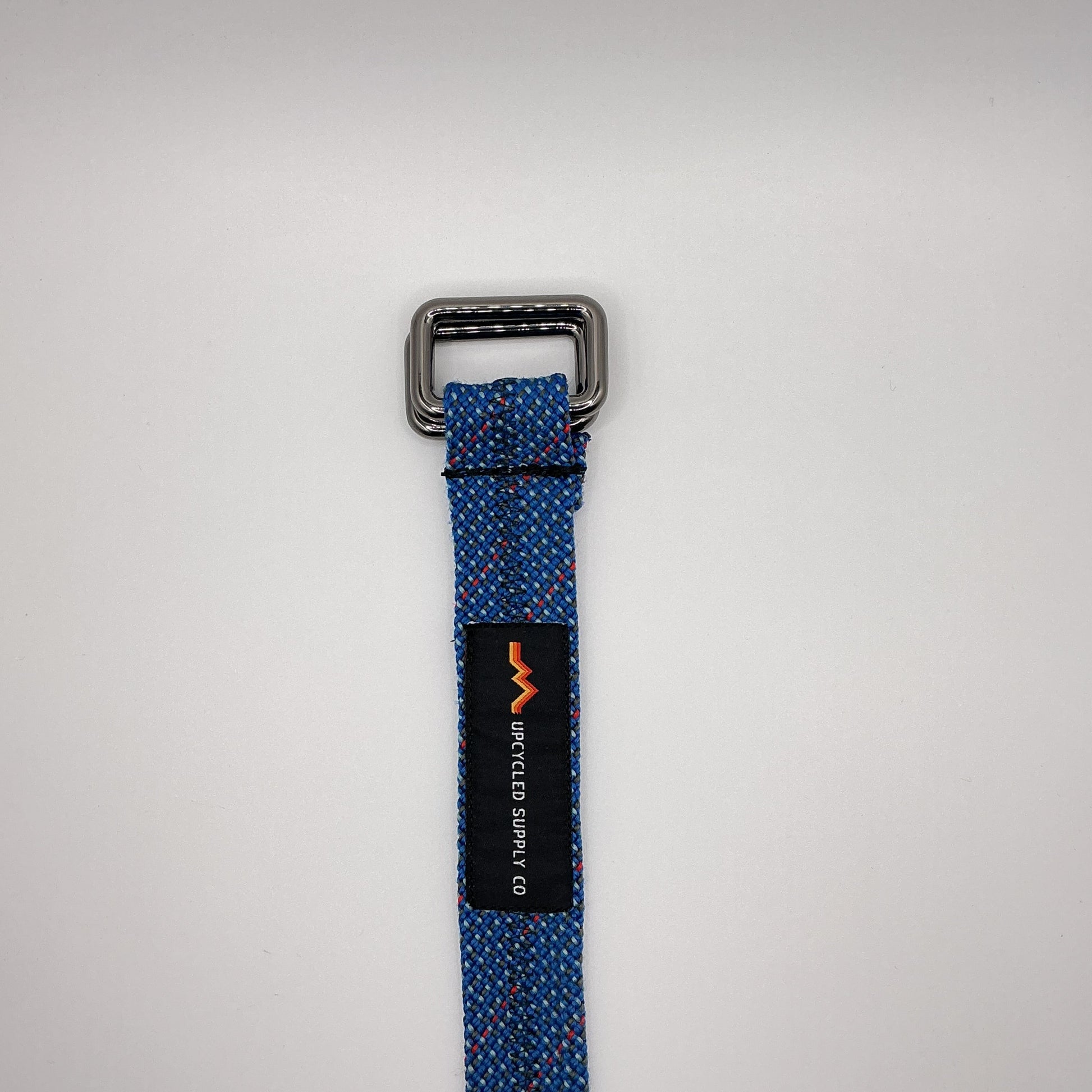 Blue webbing strap with a metal buckle on a white background