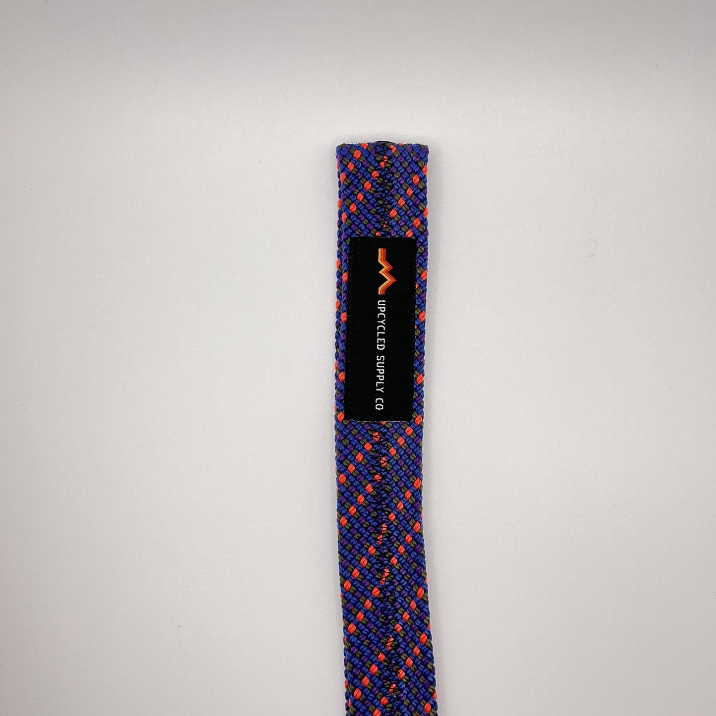 Blue and orange braided rope with a black label on a gray background