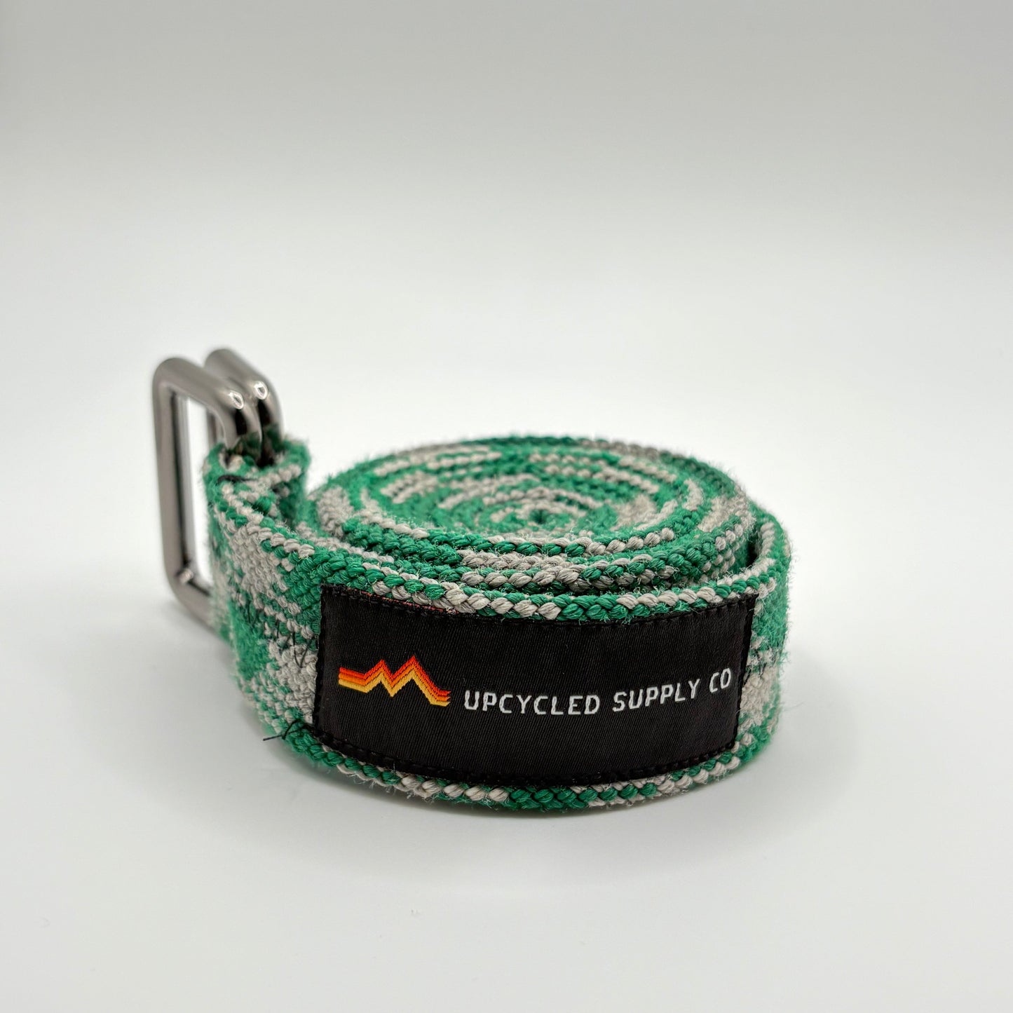 Green and gray striped belt with a brand label on a white background