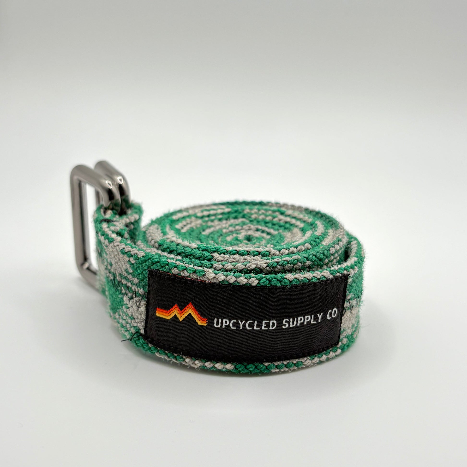 Green and gray striped belt with a brand label on a white background
