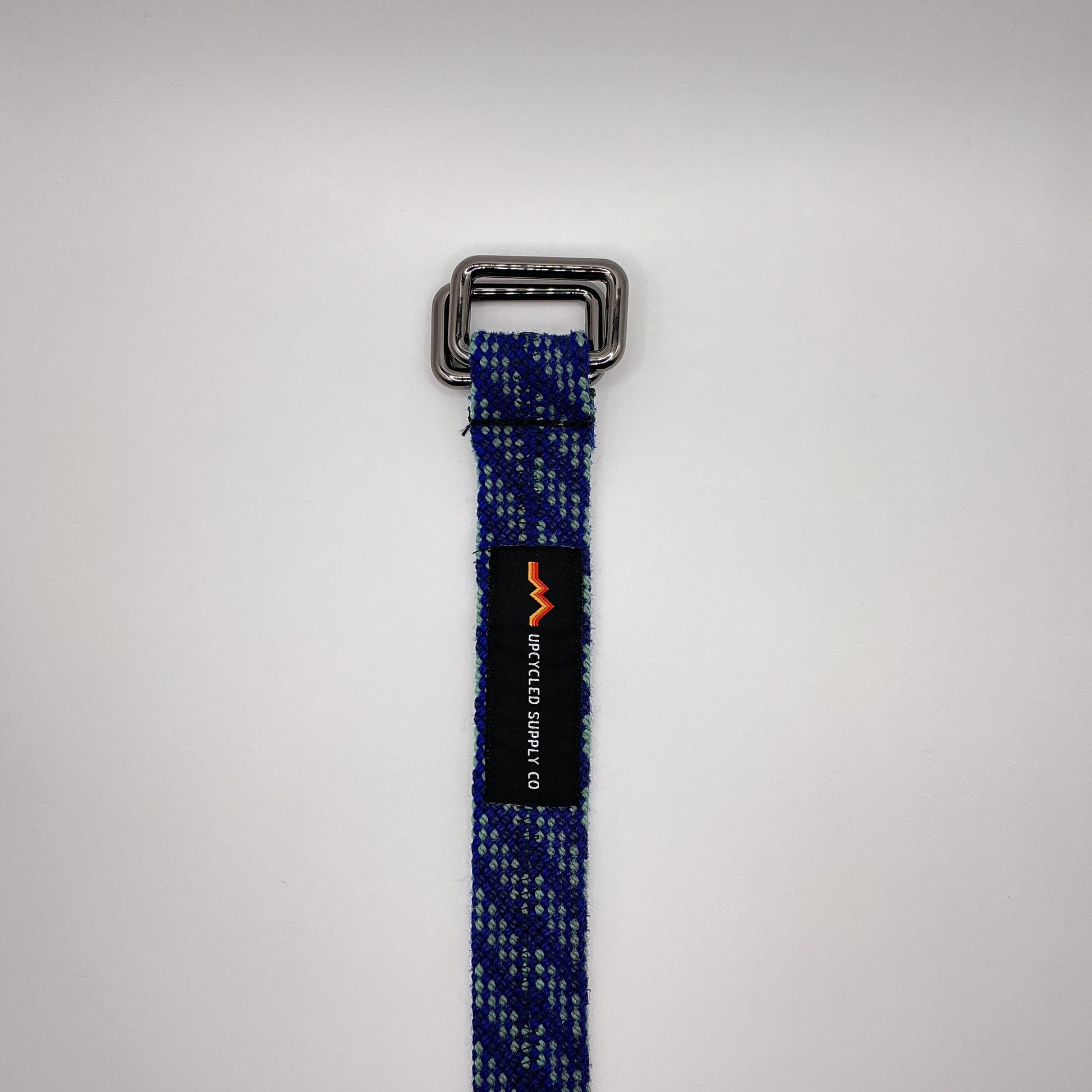 Blue webbing strap with a metal buckle on a white background