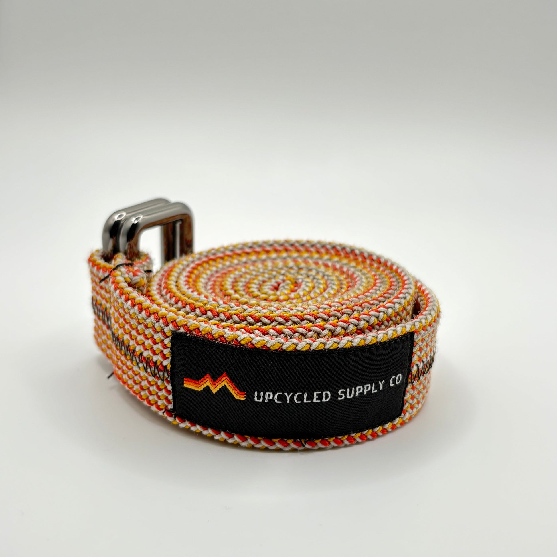 belt with a brand label on a light gray background